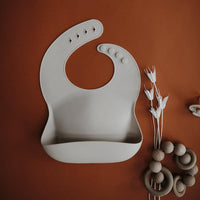 Mushie Silicone Baby Bib, Sand - Hello Little Birdie