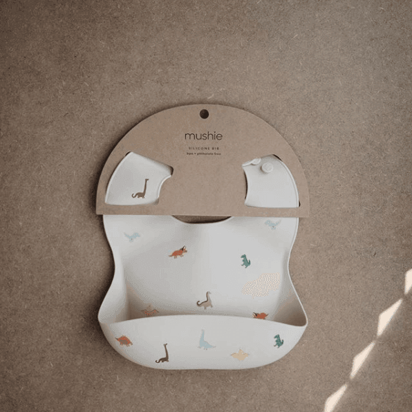 Mushie Silicone Baby Bib, Dinosaurs - Hello Little Birdie